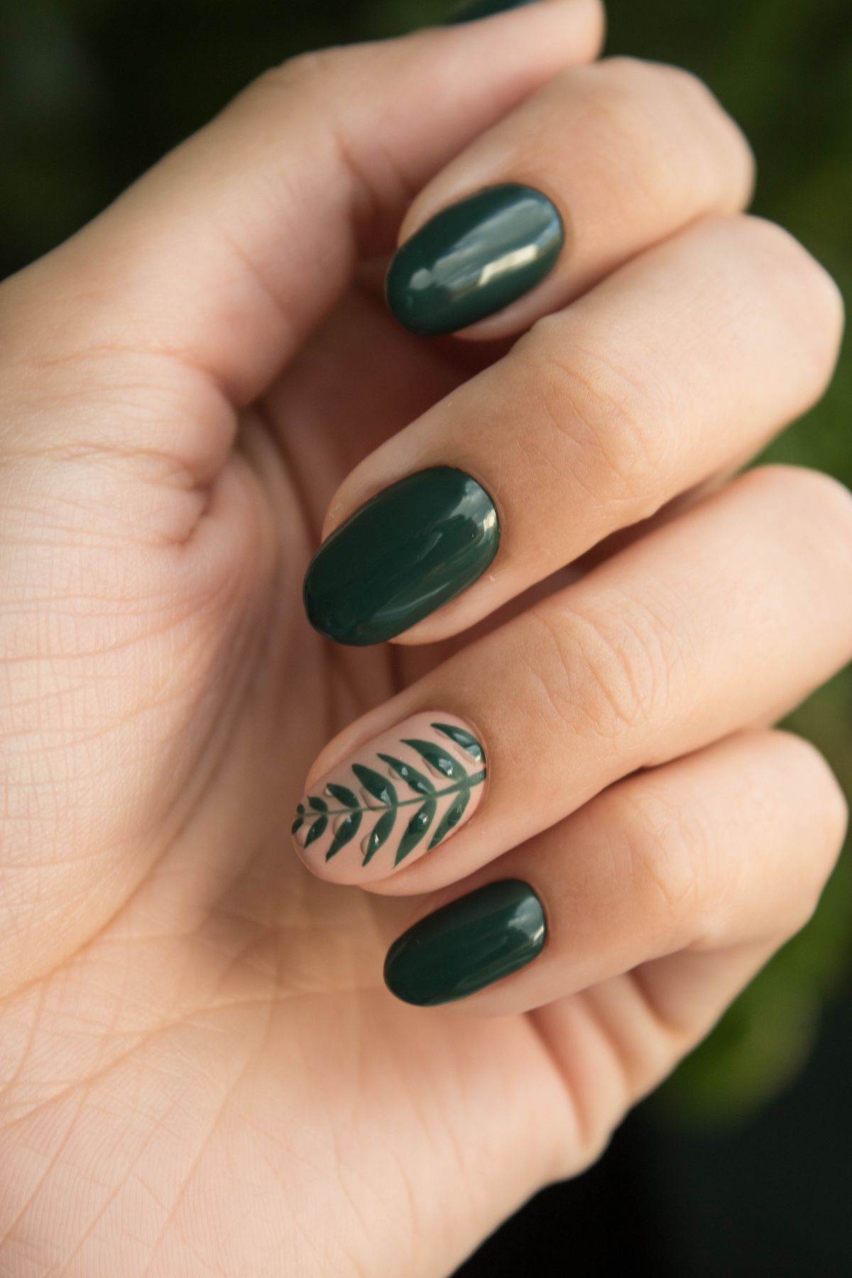 Sage green manicure with leaf nail art
